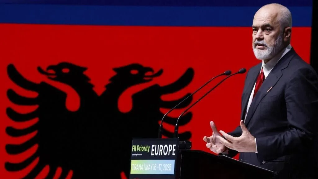 Edi Rama talking in front of EU Desk, with Albanian Flag in the background