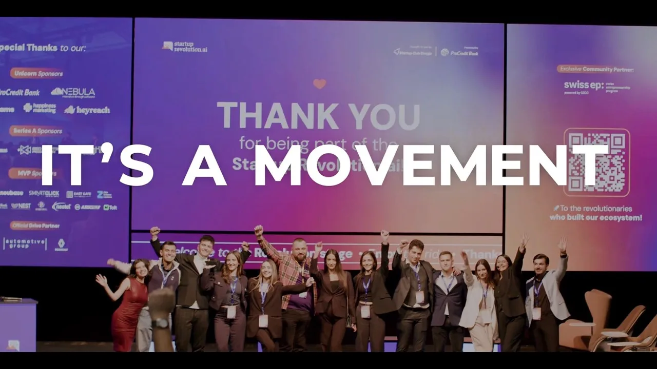 A group celebrates onstage beneath “IT’S A MOVEMENT” and a “Startup Revolution” thank-you backdrop.